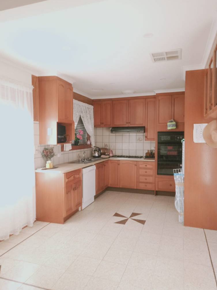 A kitchen with wooden cabinets

Description automatically generated with medium confidence